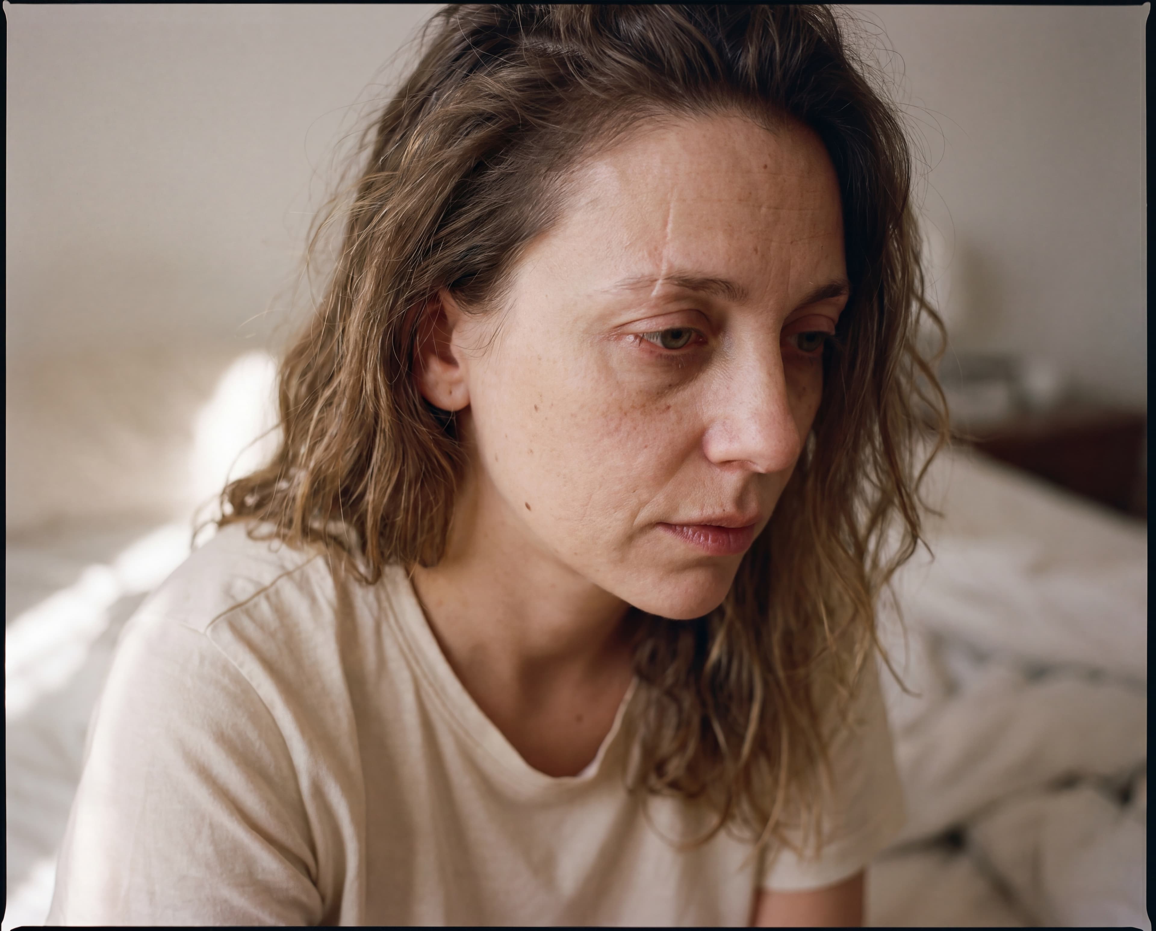 Woman leaning against a kitchen counter with coffee
